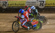 Tate Zischke of Belle Vue Aces in blue rides inside Adam Ellis of Ipswich Witches in white...