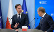 Polish Prime Minister Donald Tusk (R) and NATO's Secretary-General Mark Rutte (L) address...