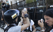 A woman affected by pepper spray is assisted during a demonstration against Argentina's Pr...