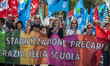 Teachers shout slogans and wave flags as they take part in a demonstration to demand the r...