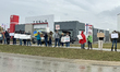 DETROIT,MICHIGAN-March 29:  Protestors holding signs line Orchard Lake Road in front of a...