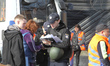 National Police officers write down the personal information of people affected by a large...