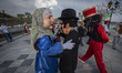 Masked men play the roles of a traditional Iranian man, a woman, and a Hajji Firus (an Ira...