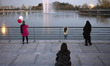 Iranian women and a young girl stand on the shore of the Art lake during a flag ceremony,...