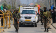 Indian Security Personnel patrol as Kashmiri Pandits participate in a religious procession...