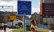 Border markings and shields are seen at the end of the bridge connecting the cities of Fra...
