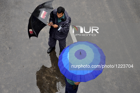 Citizens waking with Umbrella on the streets of Dhaka after heavy rainfalls caused by cyclone 'Roanu' in Bangladesh. On May 21, 2016 Rains,...