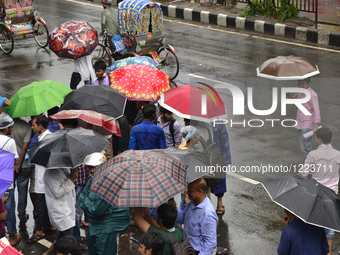 Citizens waking with Umbrella on the streets of Dhaka after heavy rainfalls caused by cyclone 'Roanu' in Bangladesh. On May 21, 2016 Rains,...