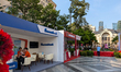 Sacombank and Agribank set up promotional booths along a pedestrian area near the Saigon O...