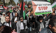 Tunisian lawyers dress in legal gowns with the Palestinian scarf (keffiyeh) on their shoul...