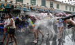 Thai and foreign tourists participate in a water gun battle as part of the annual Songkran...