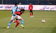 Al-Ahly player Emam Ashour is in action with a Pyramids player during a match between Al A...