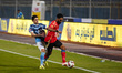 Al-Ahly player Hussein Elshahat is in action with Pyramids player Mohamed Hamdy during a m...