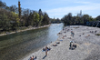 People enjoy a sunny spring afternoon on the banks of the Isar River in Munich, Bavaria, G...