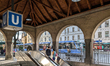 People exit the Max-Weber-Platz U-Bahn station near a tram stop in Munich, Germany, on Apr...