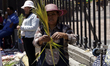 An artisan makes a palm branch during the solemn Mass for Palm Sunday to bless the palm br...
