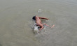 An indian kid takes bath in Ganges river to beat the heat, during a hot day in Allahabad o...
