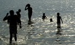 Indian people take bath in Ganges river to beat the heat, during a hot day in Allahabad on...