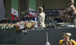 Iranian President Masoud Pezeshkian stands with military commanders as military personnel...