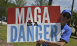 Anti-Trump protesters display signs in front of a Tesla Store in Kissimmee, Florida, US. 