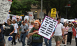 Demonstrators attend a rally at City Hall in Houston, Texas, on April 19, 2025, as part of...