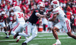 Wisconsin Badgers quarterback Billy Edwards Jr. #9 hands the ball off to running back Dili...