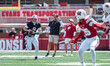 Wisconsin Badgers quarterback Billy Edwards Jr. #9 looks to pass downfield as Wisconsin Ba...