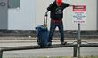 EDMONTON, CANADA - APRIL 18:A person struggling to walk atop parking barriers while carry...