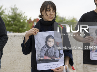 On the eve of Holocaust Remembrance Day, Israeli activists hold up photographs of Palestinians from Gaza who were killed during the war, in... by Yahel Gazit/NurPhoto