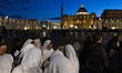 A group of nuns waits their turn to visit in front of St. Peter's Basilica as visitors and...