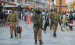 Indian paramilitary soldiers patrol past Indian tourists near the clock tower (Ghanta Ghar...