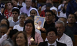 A person holds a photograph of Pope Francis during a solemn Eucharist at the Metropolitan...