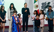 Mexico's President Claudia Sheinbaum Pardo, accompanied by children, speaks during a brief...