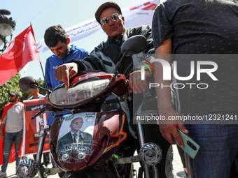 A supporter displays a poster of President Kais Saied on his motorcycle during a rally held by supporters of Tunisian President Kais Saied o... by Chedly Ben Ibrahim/NurPhoto