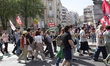 People hold flags and banners during the May Day demonstration in Lisbon, Portugal, on May...