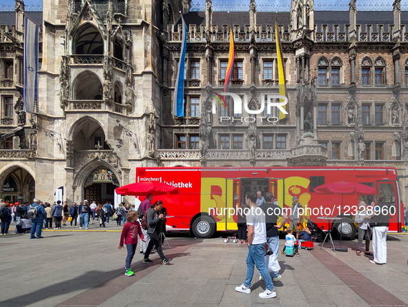 The Munich City Library's red book bus stands in front of the New Town Hall at Marienplatz during the Open Day of the City of Munich in Muni... by Michael Nguyen/NurPhoto