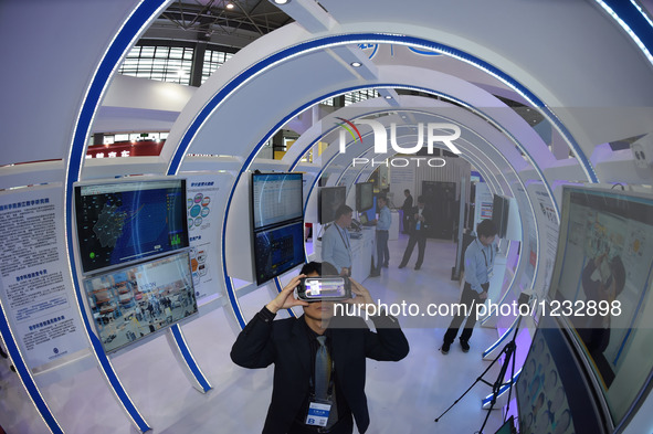 A visitor gives a trial for a VR technology product during Guiyang International Big Data Expo 2016 in Guiyang, capital of southwest China's...