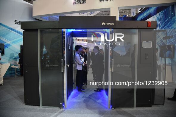 Visitors consult at a booth of server products during Guiyang International Big Data Expo 2016 in Guiyang, capital of southwest China's Guiz...