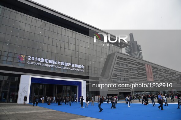 Visitors walk into Guiyang International Conference and Exhibition Center, venue of Guiyang International Big Data Expo 2016, in Guiyang, ca...