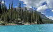 The vivid blue waters of Moraine Lake, framed by the Valley of the Ten Peaks, are seen in...