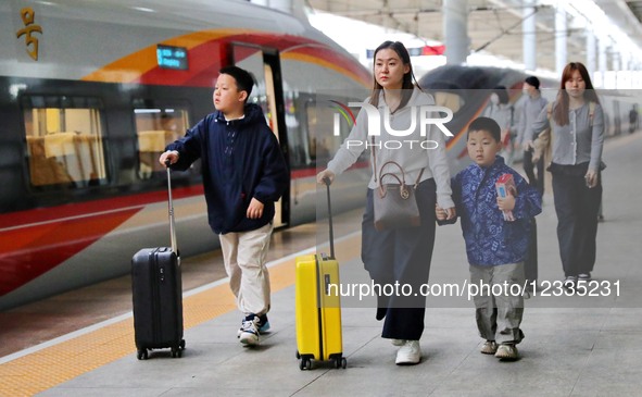 Passengers get ready to take the train at Qinhuangdao Railway Station in Qinhuangdao City, Hebei Province, China, on May 5, 2025.  by Costfoto/NurPhoto