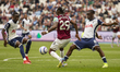 Yves Bissouma of Tottenham Hotspur tackles Aaron Wan-Bissaka of West Ham United during the...