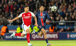 William Saliba of Arsenal (left) and Bradley Barcola of Paris Saint-Germain (right) play d...