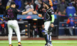 New York Mets relief pitcher Jose Butto #70 and catcher Francisco Alvarez #4 shake hands a...