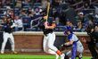 New York Mets player Tyrone Taylor #15 singles during the second inning of a baseball game...
