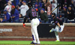 New York Mets' Juan Soto #22 throws his bat after hitting a solo home run during the fourt...