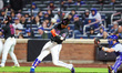 New York Mets' Juan Soto #22 singles during the eighth inning of a baseball game against t...