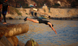 Palestinians jump into the Mediterranean Sea during the hot weather in Gaza City, on May 9...