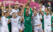 Players and coaches of Al-Sadd SC celebrate with the Qatar Cup trophy after winning the Qa...