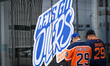 EDMONTON, CANADA - MAY 14:Fans wearing Oilers jerseys walk past a shop window featuring t...